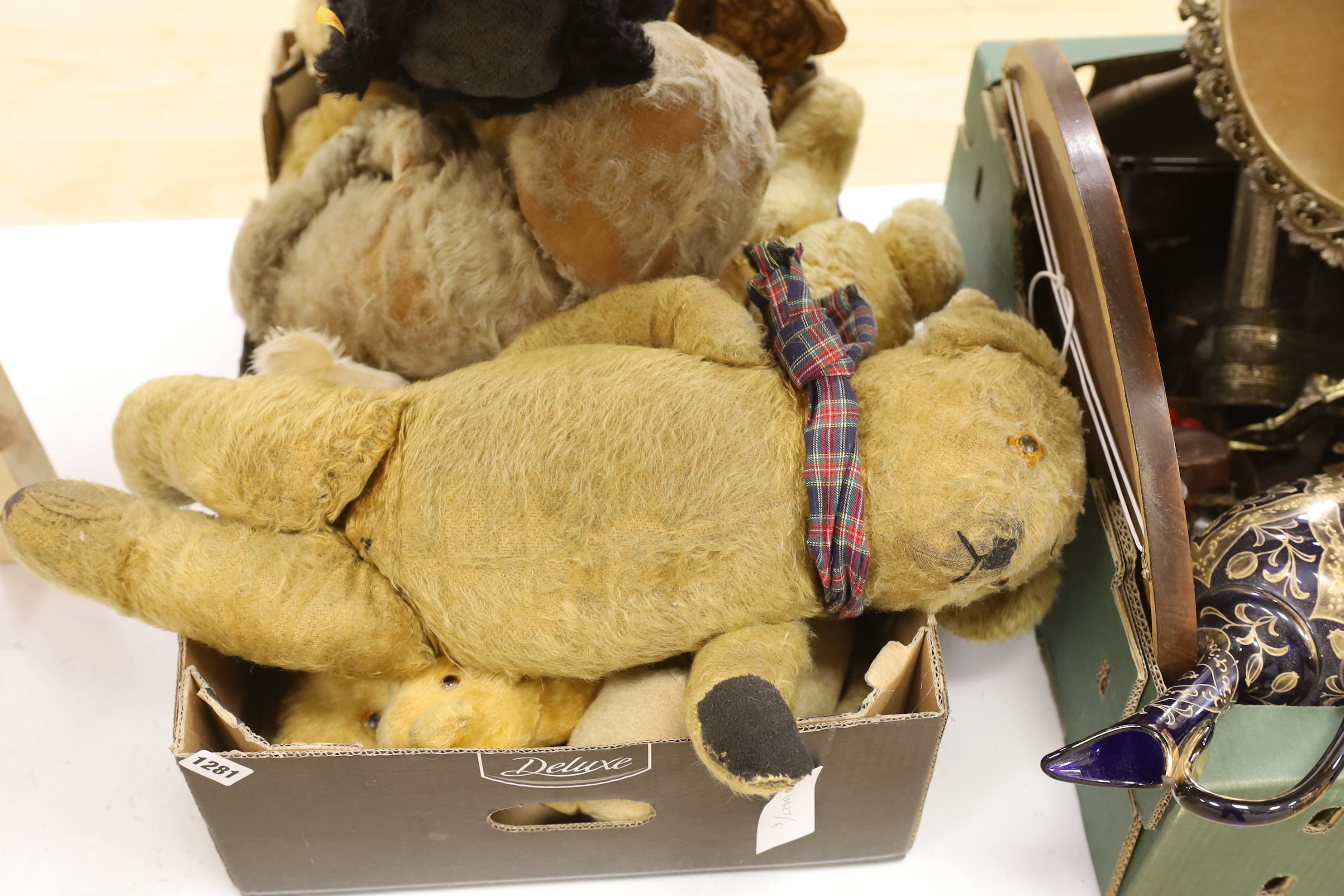 A collection of vintage and later teddy bears, some with articulated limbs, including a modern Steiff example with growler together with a seated dog, the largest 60cm in length